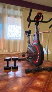 a room with a exercise bike and two stools at Hotel Sauraha Gaida House in Chitwan