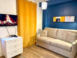 a living room with a couch and a tv at Dalikyda - La Bulle - Loveroom in Le Havre