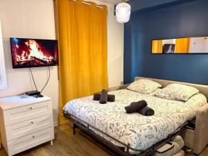 a bedroom with a bed with a tv on the wall at Dalikyda - La Bulle - Loveroom in Le Havre