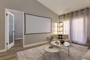 a living room with a large window and a table at Casablanca - 3 BR Family & Game Haven in Calgary