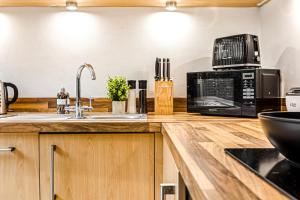 a kitchen with a sink and a microwave at The Viva Apartments Luxe in Birmingham