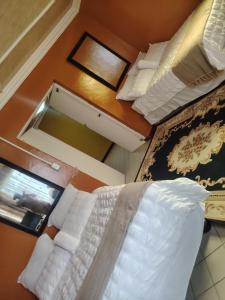 an overhead view of a bedroom with a bed and a mirror at Molata Rabs in Polokwane +18 photos