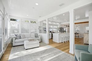 a living room with a couch and a kitchen at Waterfront Retreat Events Dock in St. Augustine
