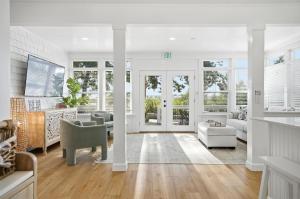 a living room with white walls and wood floors at Waterfront Retreat Events Dock in St. Augustine