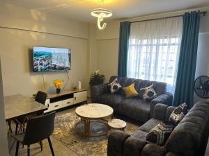 a living room with a couch and a table at Serene Lakeside Haven in Kisumu