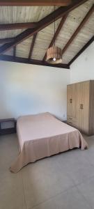 a bedroom with a large bed and a wooden ceiling at Casa Jardim in Marau +31 photos