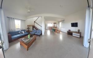 a living room with a couch and a tv at Casa Jardim in Marau
