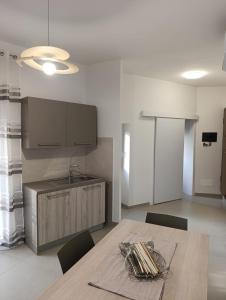 a kitchen with a table with chairs and a sink at B&B al Vicolo in Nicosia +24 photos