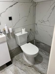 Gornji VakufDM Rooms lll的浴室设有白色卫生间和大理石墙壁。