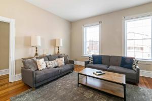 a living room with two couches and a coffee table at Pet-Friendly Benton Park 1BR Apt with Private Backyard in Soulard