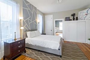 a bedroom with a bed and a dresser and a window at Pet-Friendly Benton Park 1BR Apt with Private Backyard in Soulard +20 photos