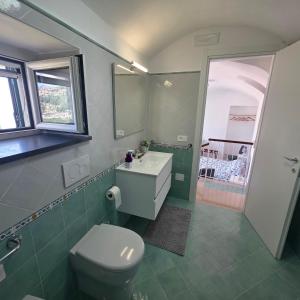 a bathroom with a toilet and a sink at JANET HOUSE in Amalfi