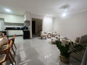 a living room with a couch and a table at Chácara Aricanga in Aracruz