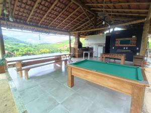 a pool table in a room with a view at Chácara Aricanga in Aracruz