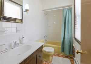 a bathroom with a sink and a toilet and a tub at Classic American-style, 18 min to NYC in Carlstadt