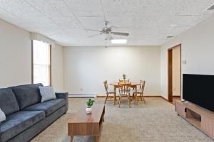 a living room with a couch and a table at Classic American-style, 18 min to NYC in Carlstadt +4 photos