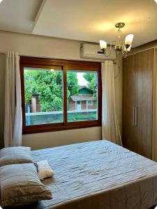 Ένα ή περισσότερα κρεβάτια σε δωμάτιο στο Apartamento em Sapiranga