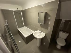 a bathroom with a sink and a toilet at Smart 2 bed apartment in Purley