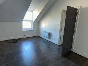 an empty room with a door and a window at Smart 2 bed apartment in Purley