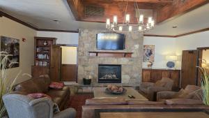 a living room with a couch and a fireplace at Romance at Riverbends' Snowflake Lift in Breckenridge