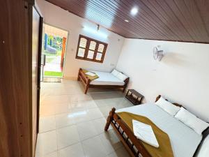 um quarto com uma cama e um banco em Rafters Retreat Coorg - The Riverside Homestay em Srimangala
