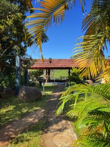 a path leading to a pavilion in a park at Rafters Retreat Coorg The Riverside Homestay in Srimangala