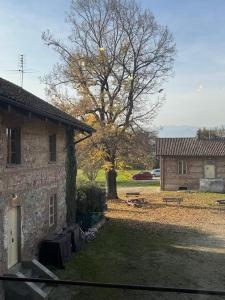 a building with a tree next to a house at La Locanda della Mandria 1 in Venaria Reale +13 photos