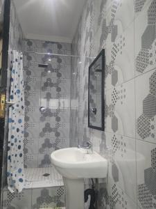 ein Badezimmer mit Waschbecken, Spiegel und Badewanne in der Unterkunft Dups Guest House, in Pietermaritzburg