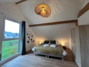 Un pat sau paturi într-o cameră la Maison des 5 cépages