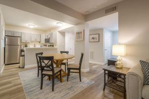 a kitchen and dining room with a table and chairs at 2BR w King Bed Pool Steps to Forest Park CWE in Tower Grove