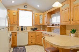 a kitchen with wooden cabinets and a white refrigerator at All-American classic,18 min to Manhattan in Carlstadt +11 photos