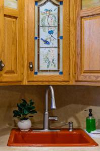 a kitchen sink with a glass window above it at All-American classic,18 min to Manhattan in Carlstadt