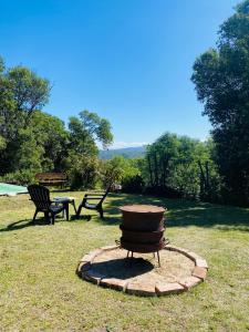 a fire hydrant and two benches in a park at Nuestro Lugar in Río Ceballos