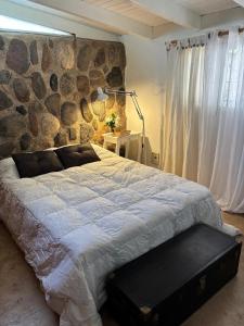 En eller flere senge i et værelse på Casa Campo La Carolina