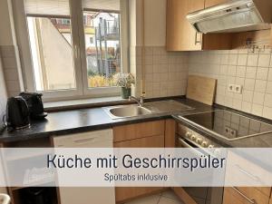 a kitchen with a sink and a window at StayWest52 - Balkon, WLAN, Parkplatz in Ulm +28 photos