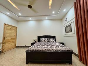 a bedroom with a bed in a room at 1 - bedroom near Lyallpur galleria in Faisalabad +20 photos