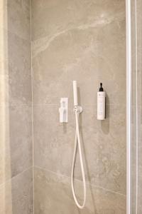 a shower with a soap dispenser on a wall at CHANTTAL Luxury - ACADEMY in Bucharest