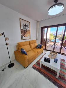 a living room with a couch and a table at Cocoonly in San Juan de los Terreros