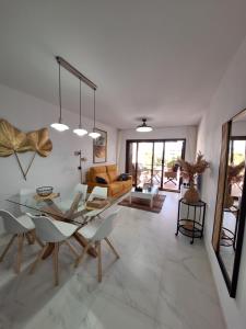 a living room with a glass table and chairs at Cocoonly in San Juan de los Terreros