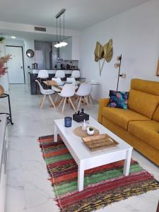 a living room with a couch and a table at Cocoonly in San Juan de los Terreros