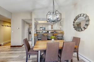a dining room and kitchen with a table and chairs at Mountainwood 303 in Breckenridge