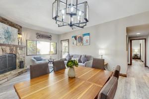 a dining room and living room with a table and a fireplace at Mountainwood 303 in Breckenridge