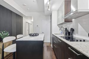 a kitchen with white walls and a counter top at Stylish Downtown Studio with CN Tower Views in Toronto +18 photos