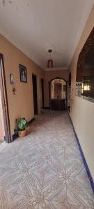 an empty hallway with a tile floor in a building at serenity house  +2 photos