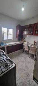 a kitchen with a stove and a table and chairs at serenity house 