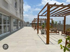 a large patio with benches on a building at Studio 107 Home Com Varanda, Ar-condicionado e Netflix in Mogi das Cruzes
