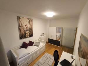 a living room with a white couch and a table at Düsseldorf Apartment in Düsseldorf