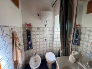 a small bathroom with a toilet and a sink at Spectacular view overlooking the famous Boracay white beach ! in Boracay +15 photos