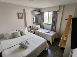 a hotel room with two beds and a ladder at Hotel JBJ in Mendoza +41 photos