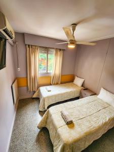 Postel nebo postele na pokoji v ubytování HOTEL JUAN B JUSTO GARDEN Pet friendly